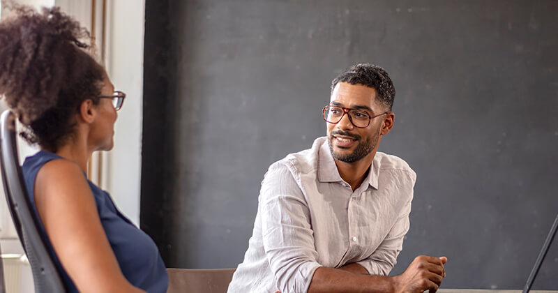 businessman looking at manager in office