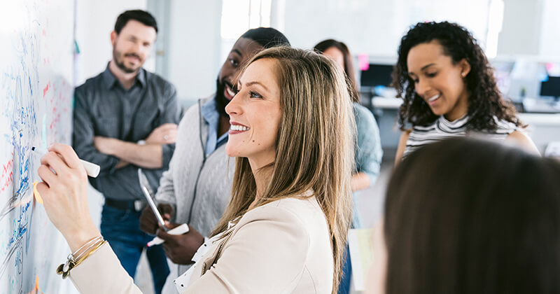 people brainstorming ideas at the board