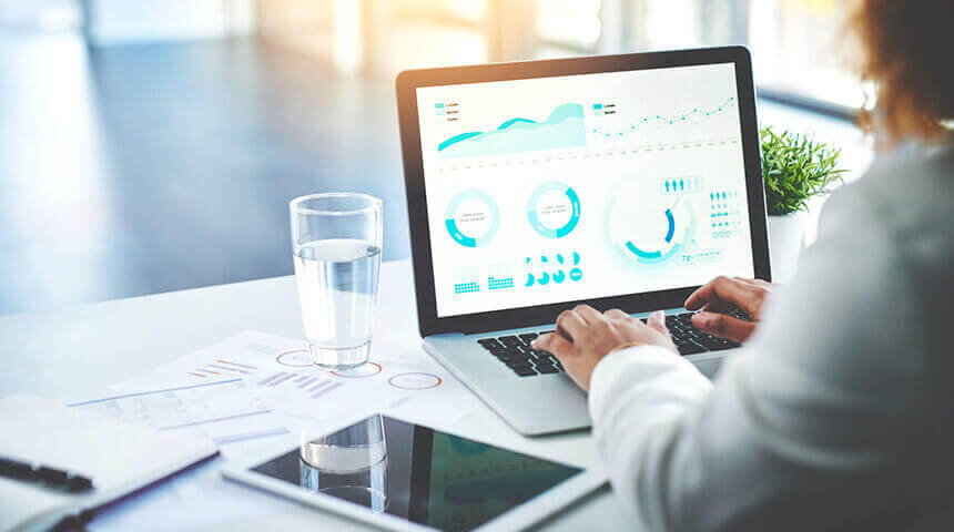 businesswoman reviewing performance on laptop