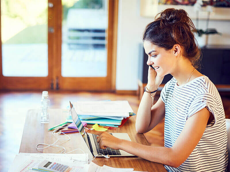 Happy woman working on laptop